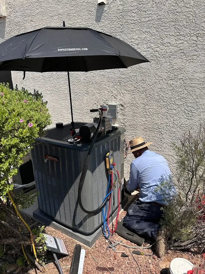 HVAC technician performing outdoor AC maintenance in Yakima